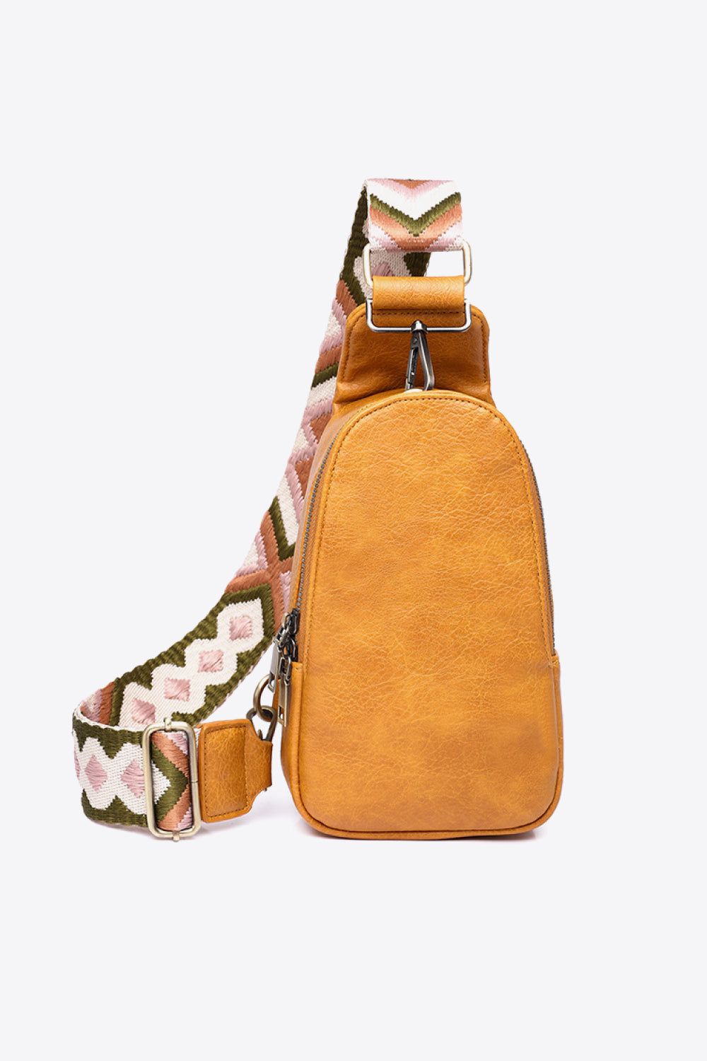 Textured mustard sling bag with woven geometric strap and adjustable buckle