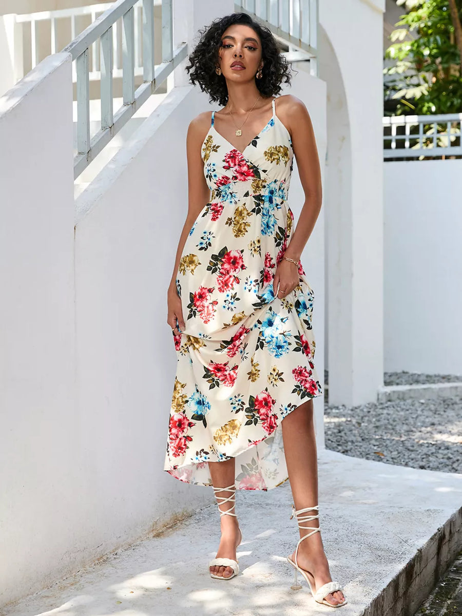 Chic floral midi dress with spaghetti straps and a V-neck in cream with red, blue, and yellow flowers.