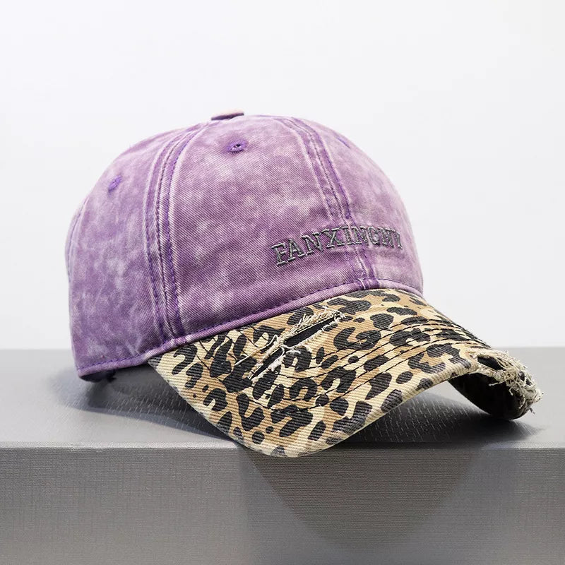 Purple distressed baseball hat with leopard print brim and frayed details