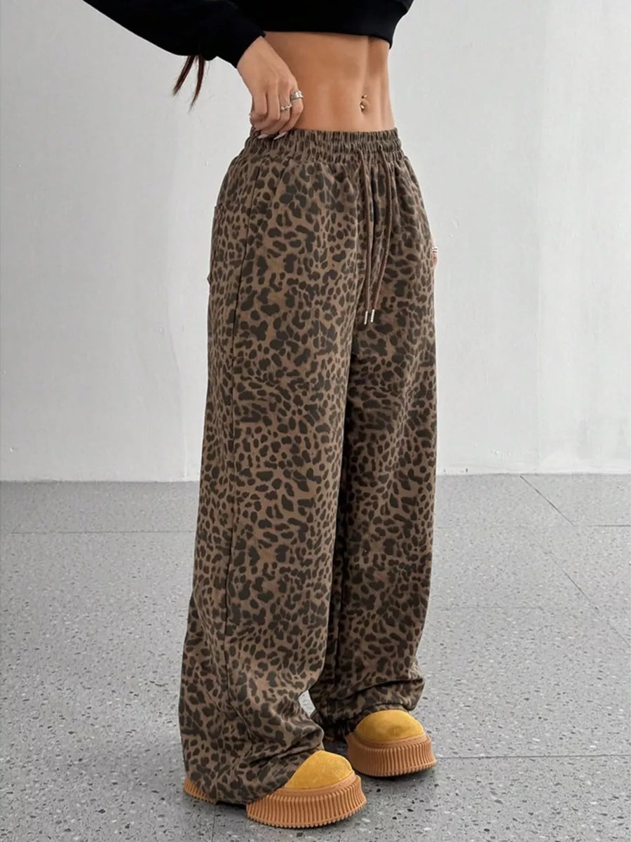 black wide-leg pants featuring drawstring waist and leopard-print