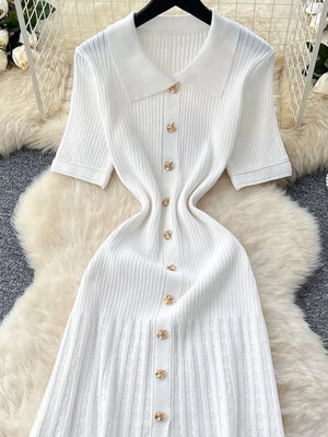 White knit Peter Pan collar dress with gold flower buttons and short sleeves.