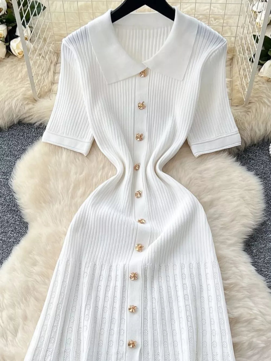 White knit Peter Pan collar dress with gold flower buttons and short sleeves.