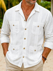 Men's white long sleeve button-up shirt with four pockets and pintuck details.