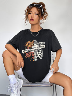 Black graphic t-shirt with skeleton and floral print, featuring text.