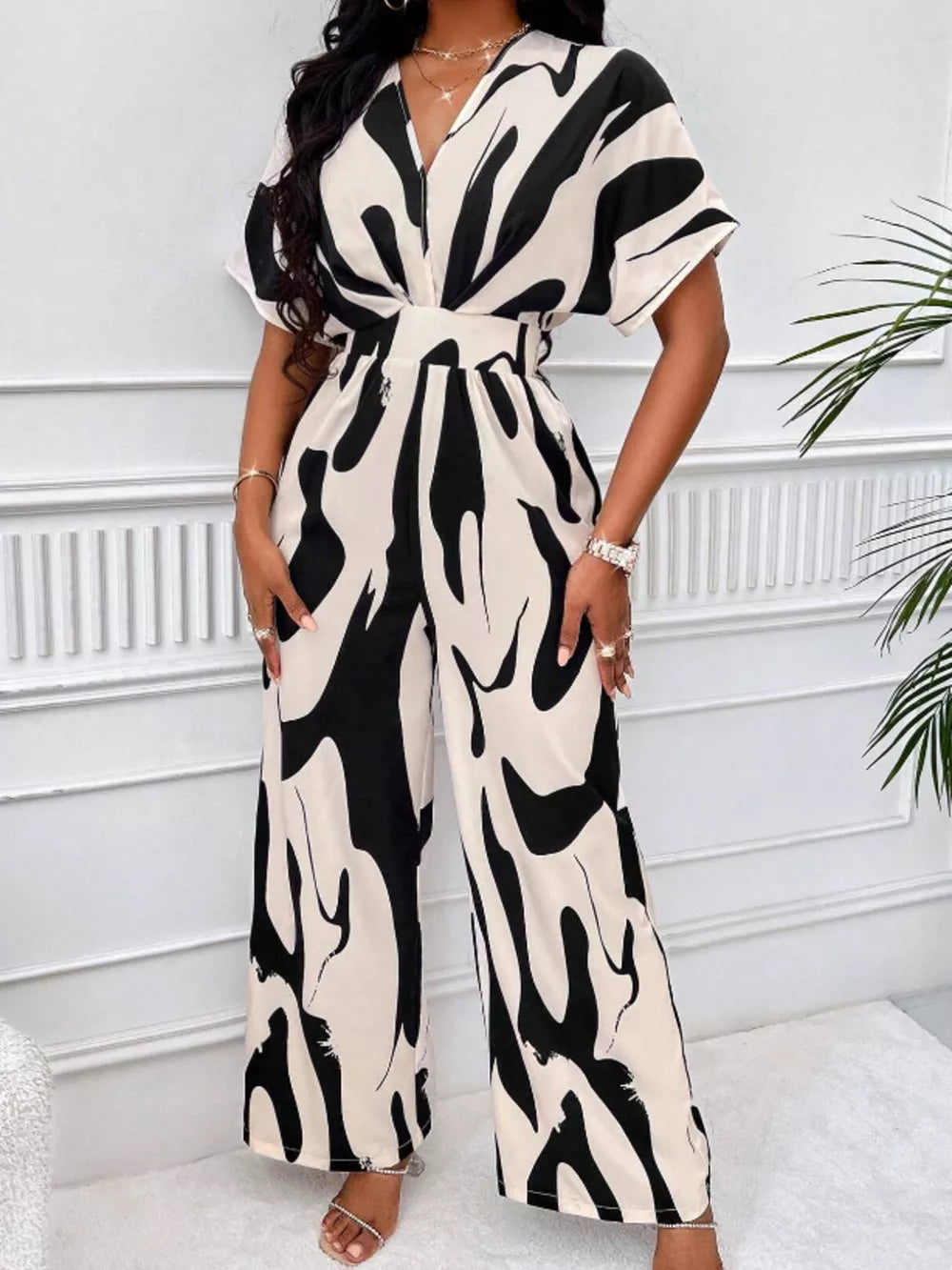 Black and white abstract print wide-leg romper with V-neck and short sleeves