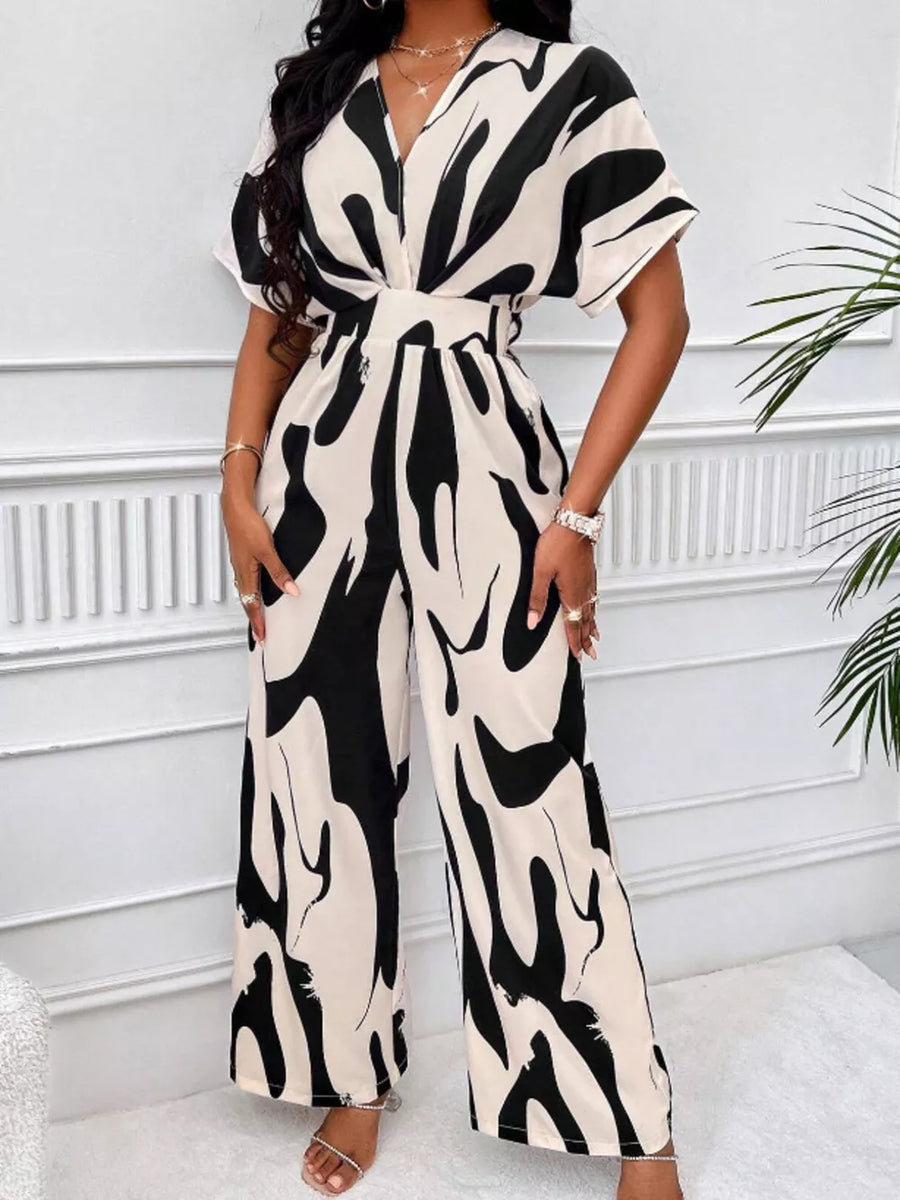 Black and white abstract print wide-leg romper with V-neck and short sleeves