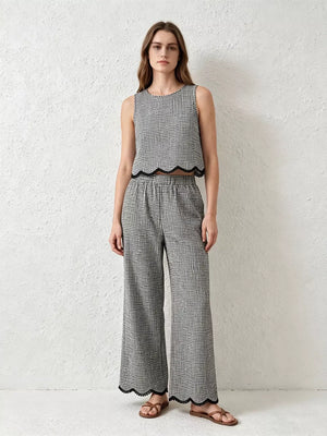 Plaid two-piece set with scalloped trim, featuring a sleeveless crop top and wide-leg pants.