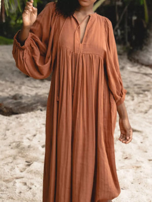 Elegant tie-neck midi dress with puff sleeves in amber.