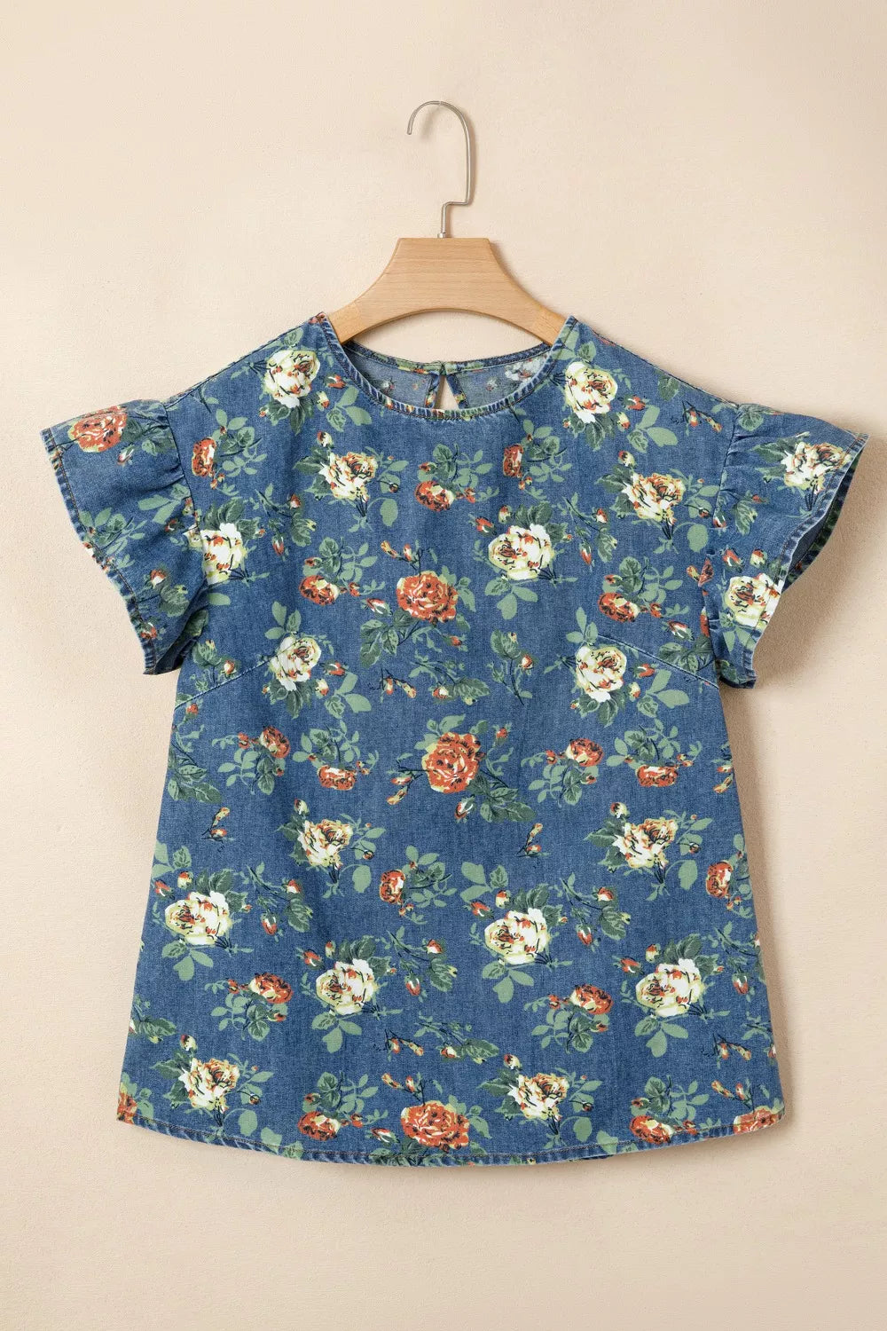 Denim floral ruffled short sleeve blouse with crew neck and back keyhole.