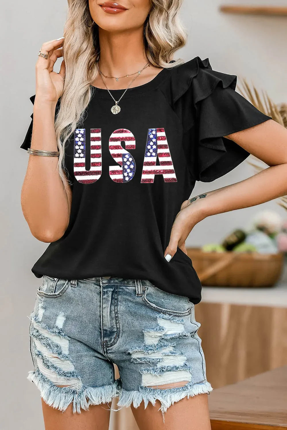 Black graphic tee with USA flag print and ruffle sleeves
