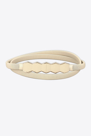 Cream elastic belt with geometric gold buckle detail