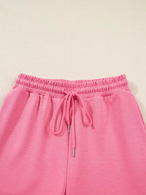 Dusty pink drawstring pants with elastic waistband and tie detail