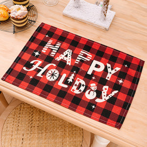 Red and black buffalo check placemat with white Happy Holidays text and snowman.
