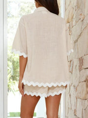Beige linen lounge set with scalloped edges on short sleeves and shorts.