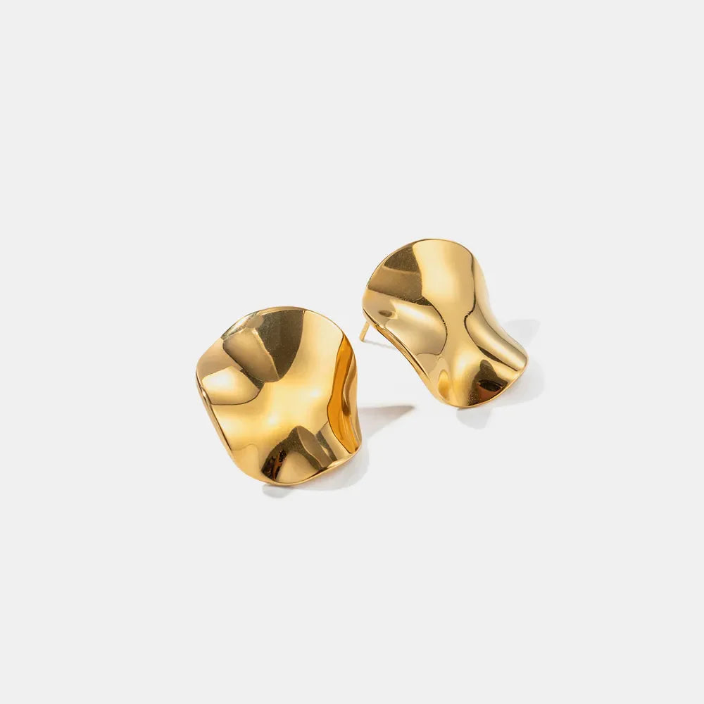 Sculpted gold wave stud earrings with a unique, organic shape.