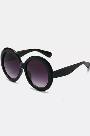Chic oversized round black fashion sunglasses with gradient purple lenses.