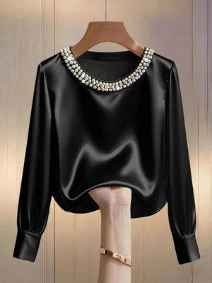 Black satin blouse with pearl trim round neckline and long sleeves.