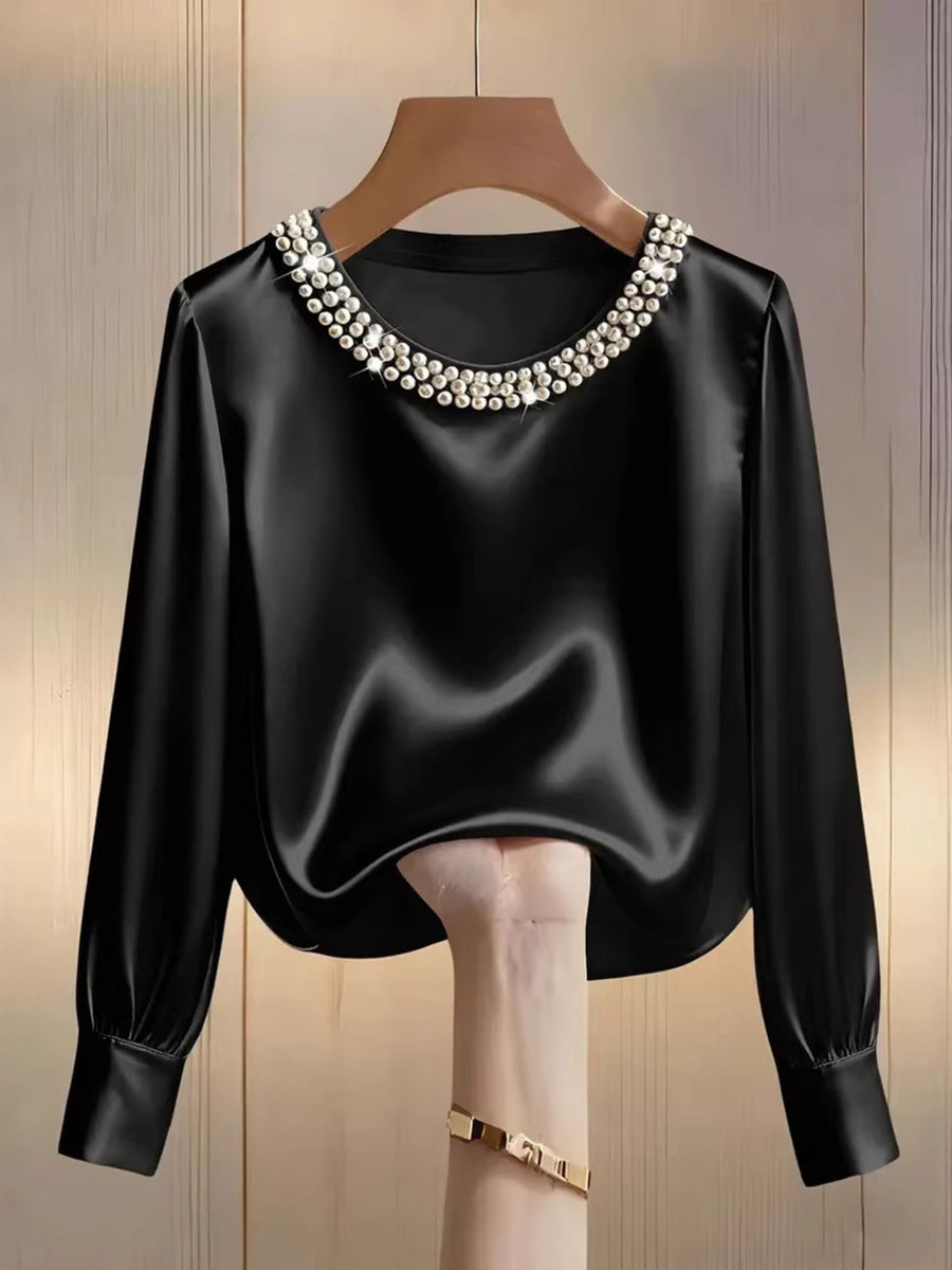 Black satin blouse with pearl trim round neckline and long sleeves.