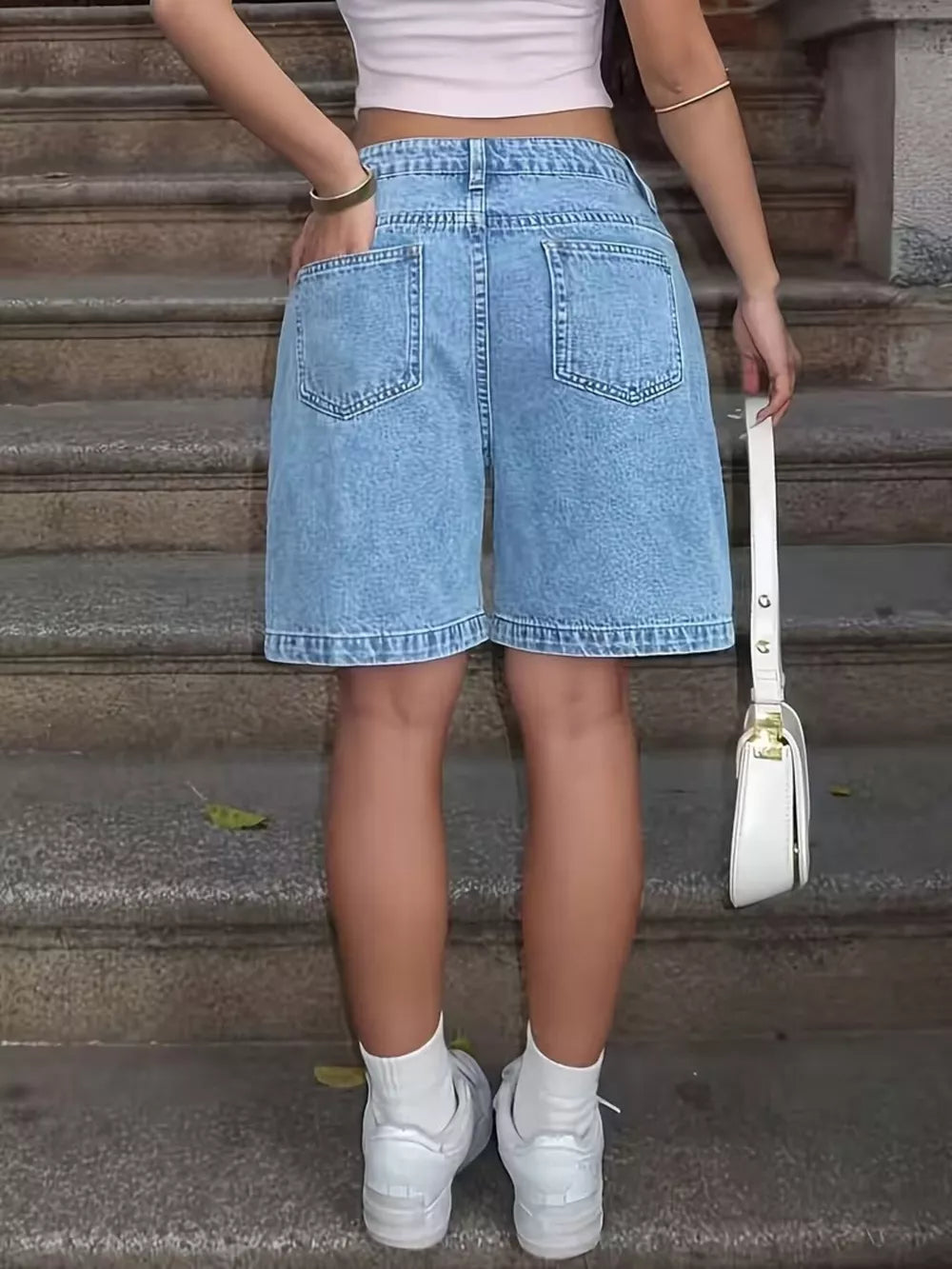 Light wash denim Bermuda shorts with a relaxed fit and classic five-pocket styling.
