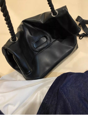 Black oversized PU leather tote bag with rope handles and a detachable strap.