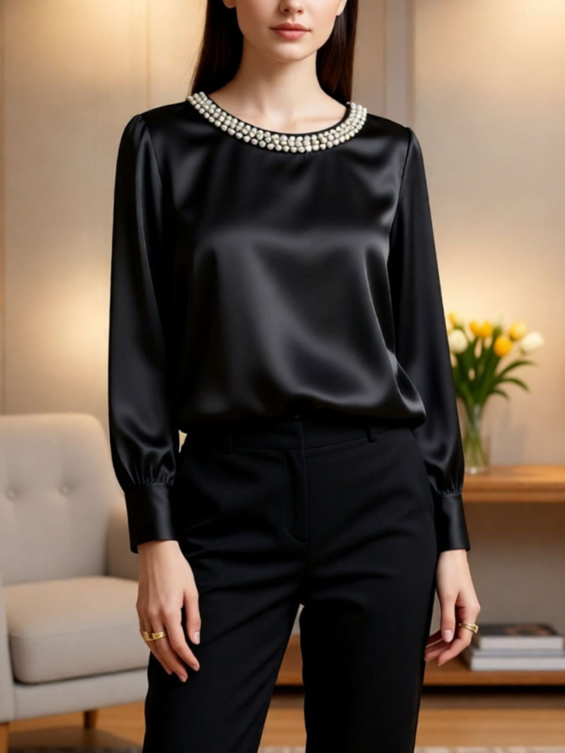 Black satin blouse with pearl trim neckline, round neck, long sleeves.