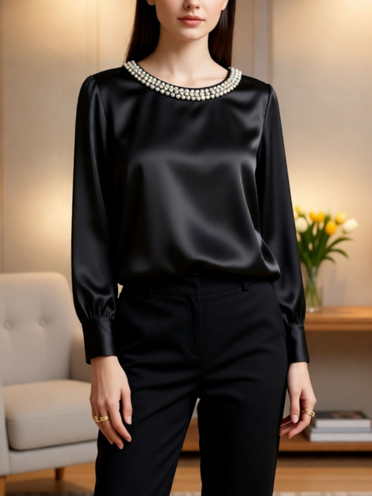 Black satin blouse with pearl trim neckline, round neck, long sleeves.