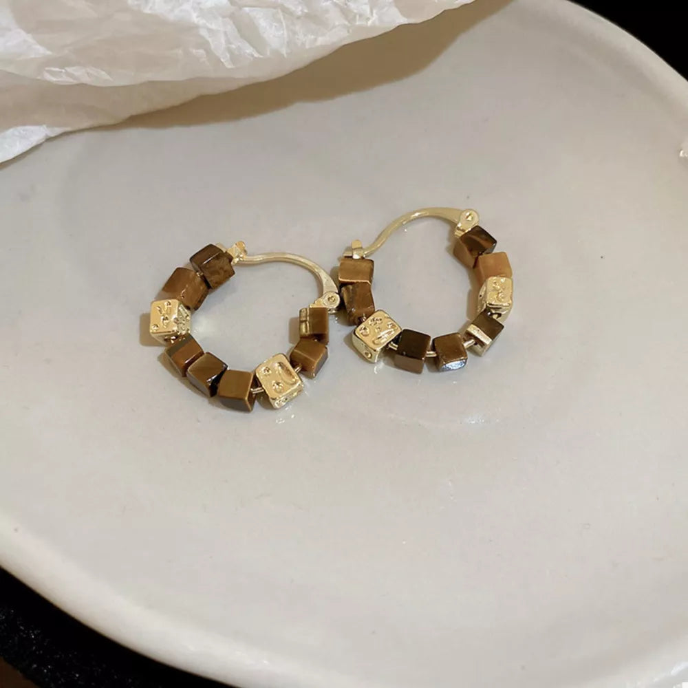 brown earrings featuring geometric beads and geometric