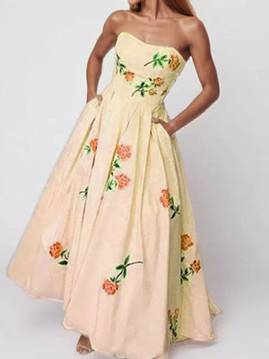 Floral print tube maxi dress in blush pink with a sweetheart neckline and pockets.