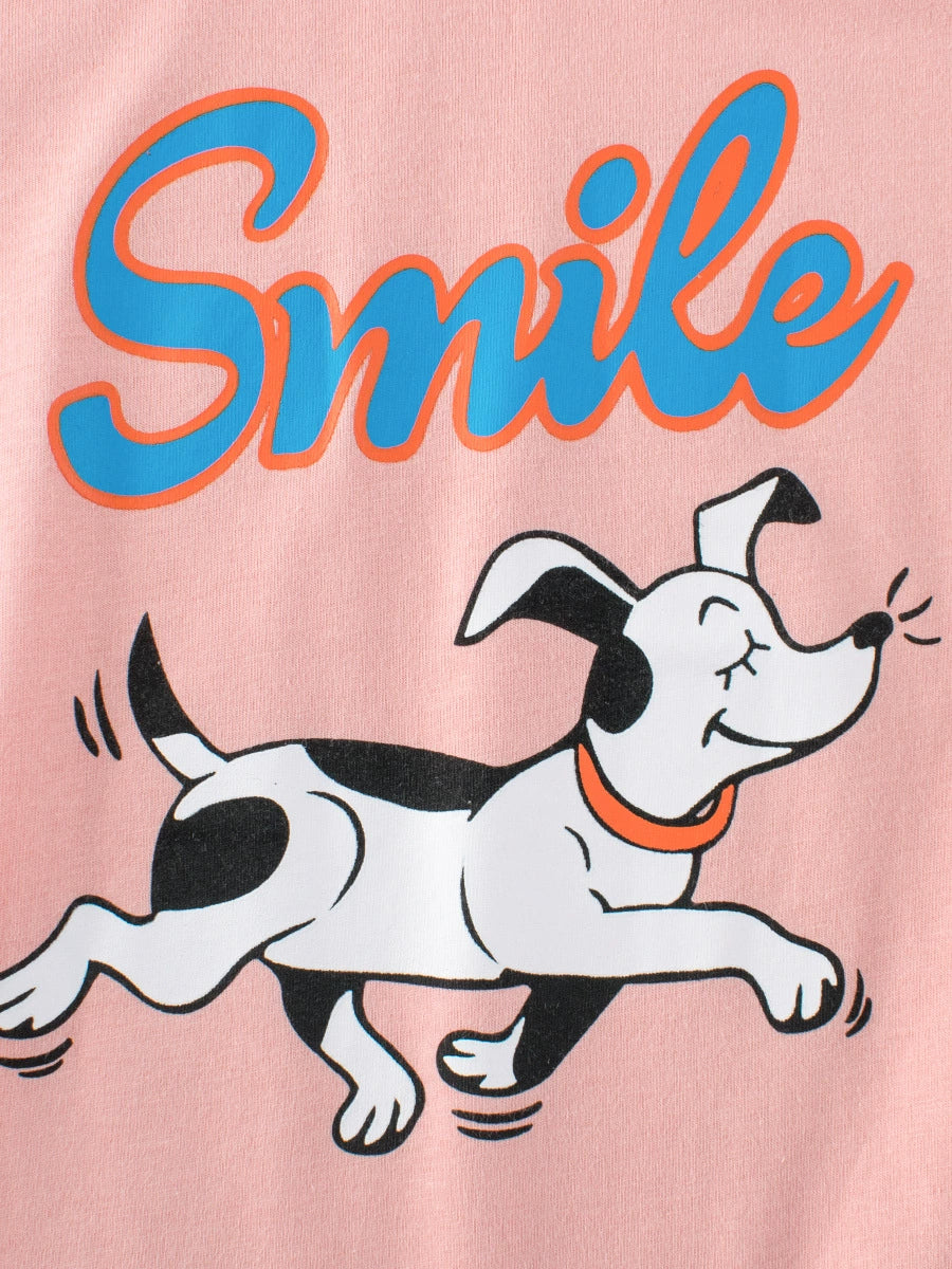 Pink t-shirt with cartoon dog and blue "Smile" text graphic