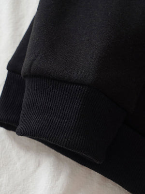 Black hoodie with ribbed cuffs and hem detail