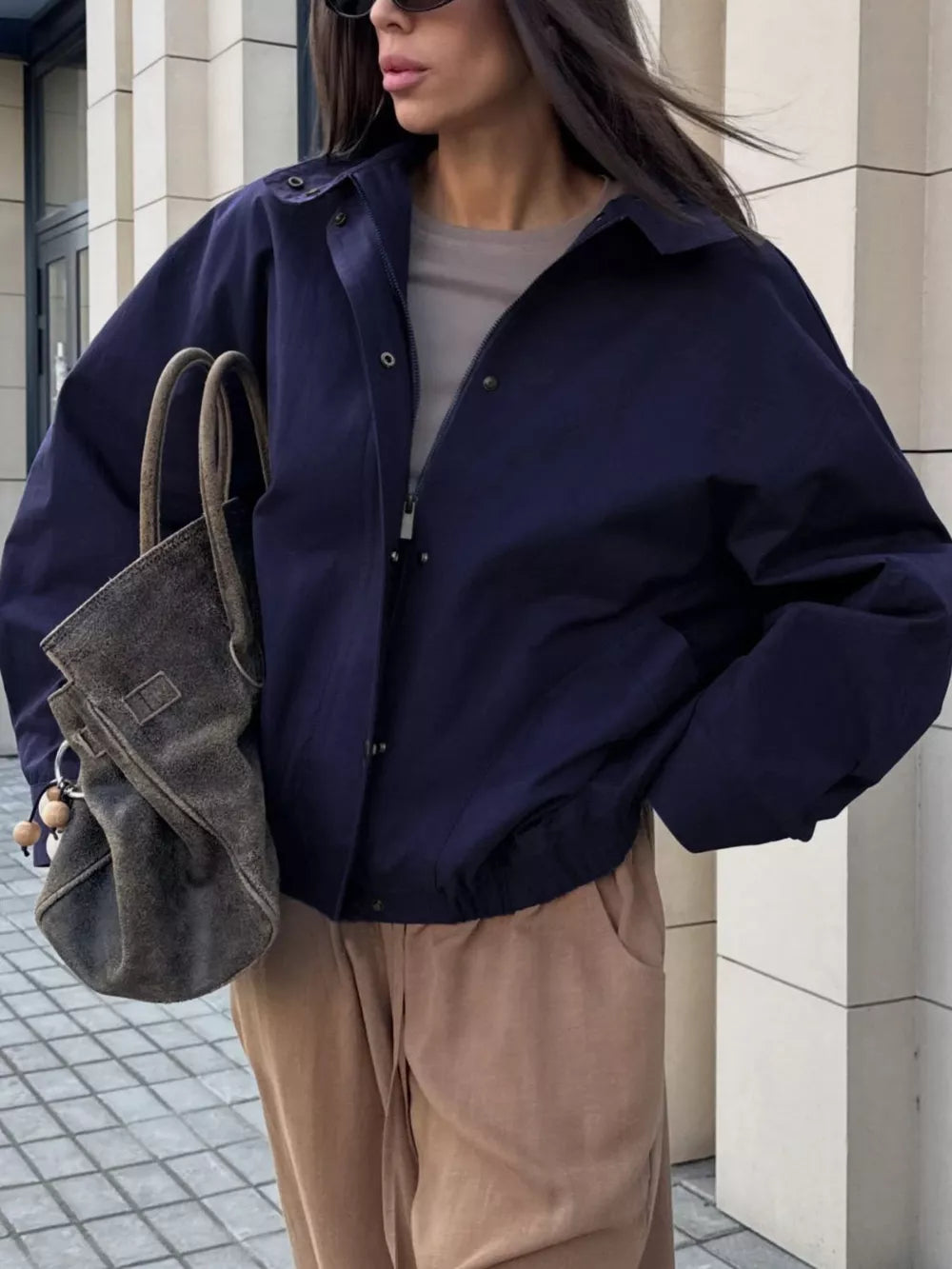 bomber jacket in navy blue featuring buttoned and relaxed fit