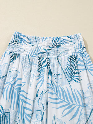 Tropical leaf print wide leg pants with smocked waist in white and blue cotton.