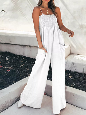 White smocked wide leg romper with spaghetti straps and side pockets.