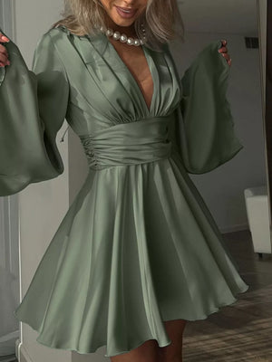 Sage green satin mini dress with deep V-neck, ruched waist, and dramatic bell sleeves.