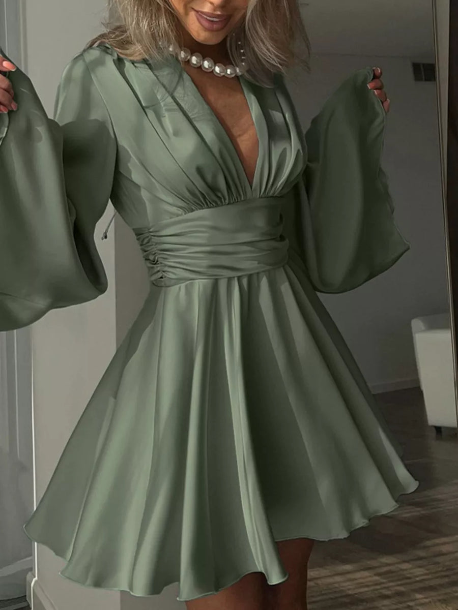 Sage green satin mini dress with deep V-neck, ruched waist, and dramatic bell sleeves.