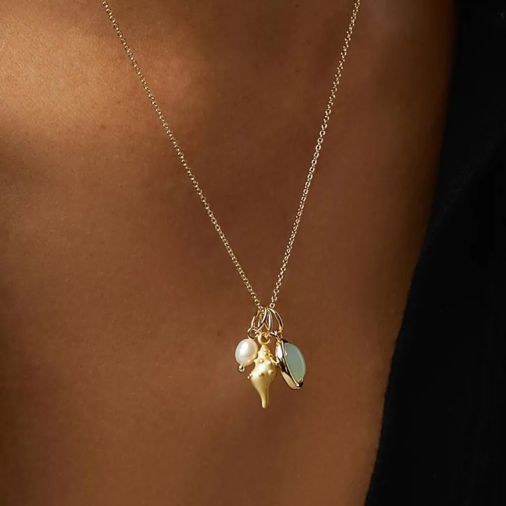 Gold seashell and gemstone charm necklace with pearl detail