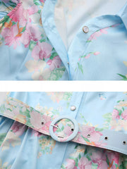 Light blue floral midi dress with ruffle sleeves and a matching belted waist.