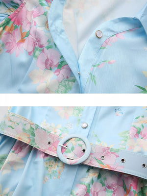 Light blue floral midi dress with ruffle sleeves and a matching belted waist.