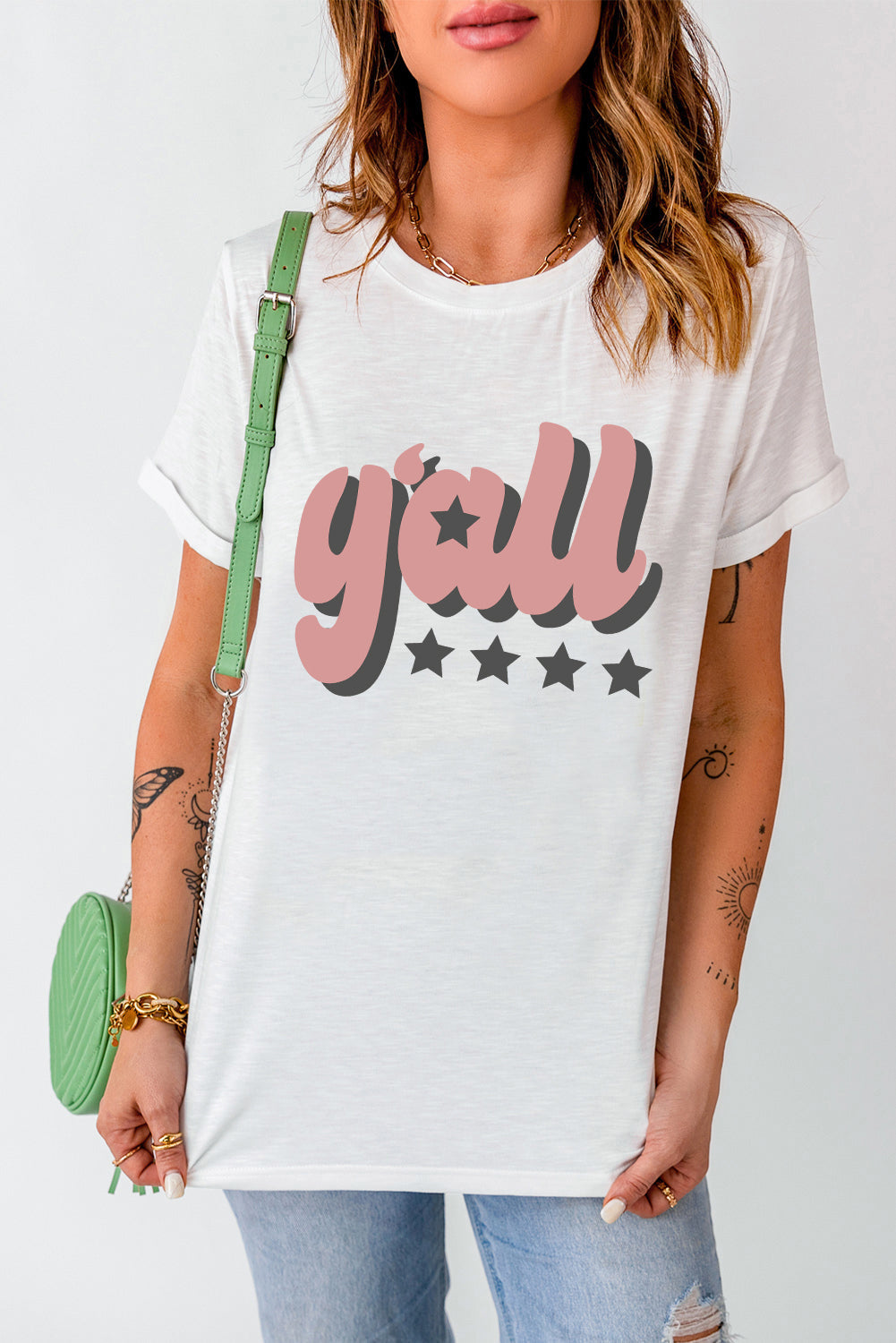 White graphic tee with retro "Y'all" text and star accents.