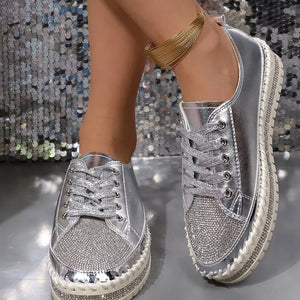 Silver rhinestone toe sneakers with chunky sole and lace-up closure.