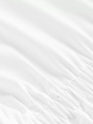 White asymmetrical button front shirt with ruched detail and collared neckline.