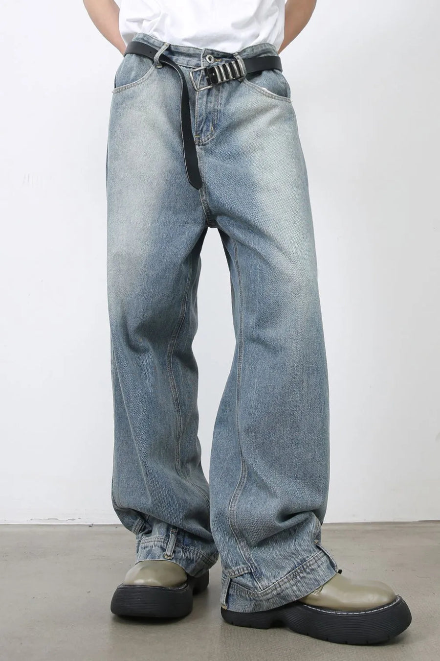 Baggy medium wash denim jeans with distressed detailing and a casual fit.