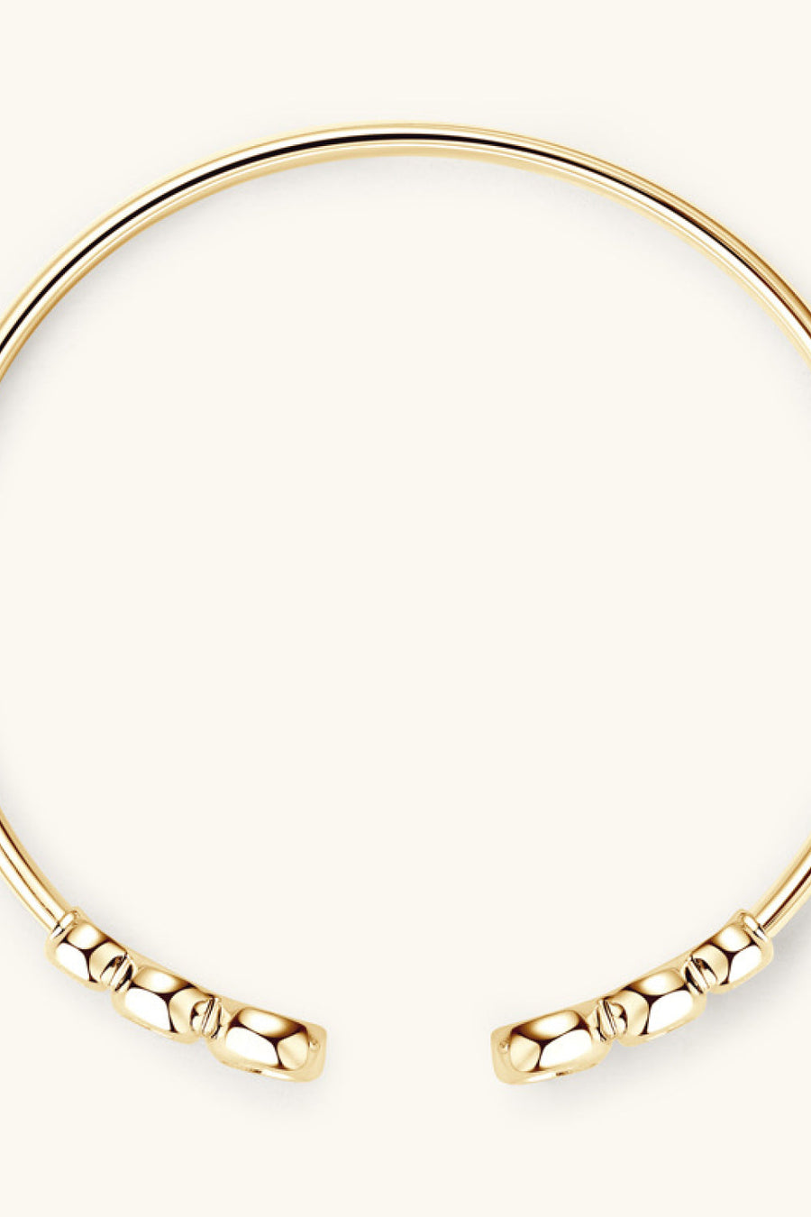 Gold open-ended cuff bracelet with faceted bead details