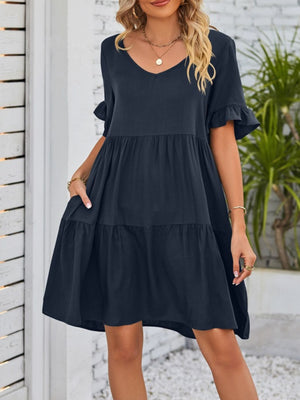 Navy ruffled sleeve mini dress with pockets and tiered skirt.