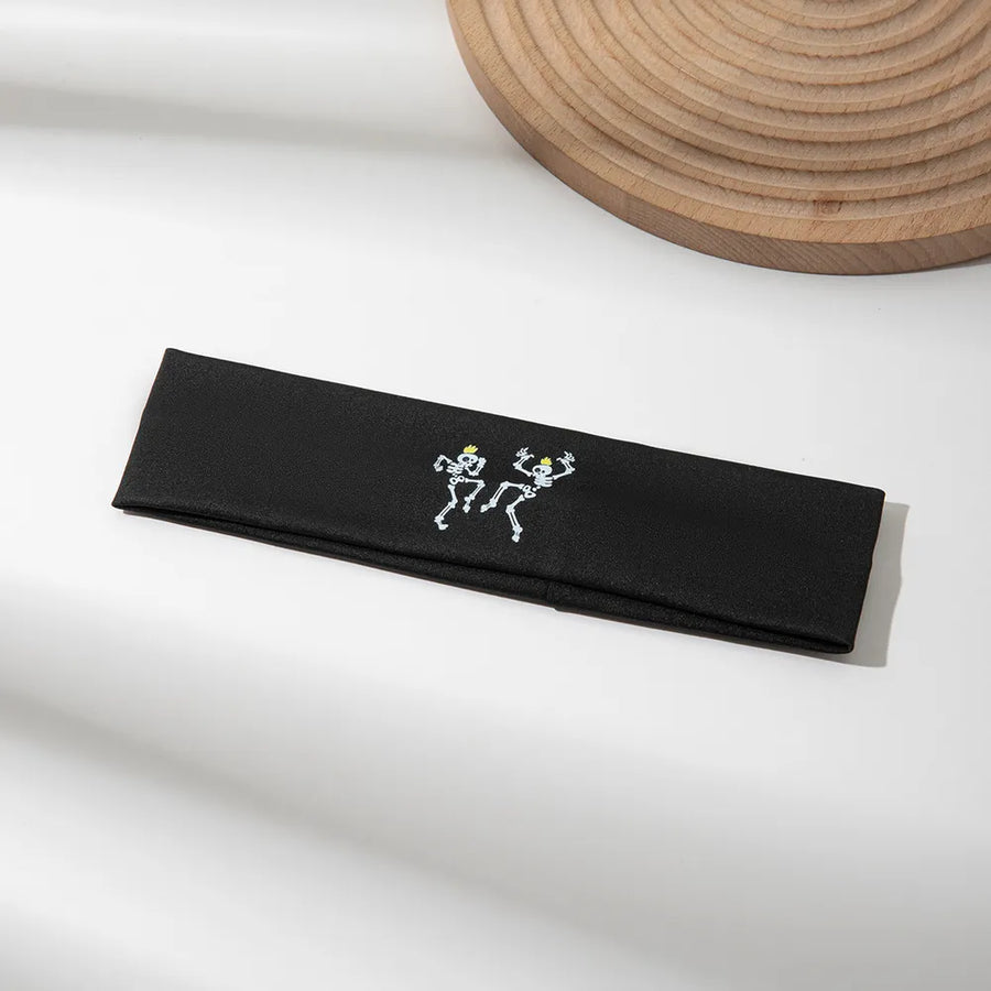 Black headband with dancing skeleton graphic, Style A