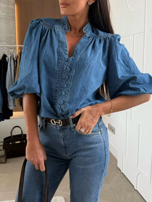 Denim button-down blouse with puff sleeves and a V-neckline.