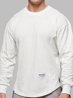 White oversized long sleeve tee with curved hem and crew neck.