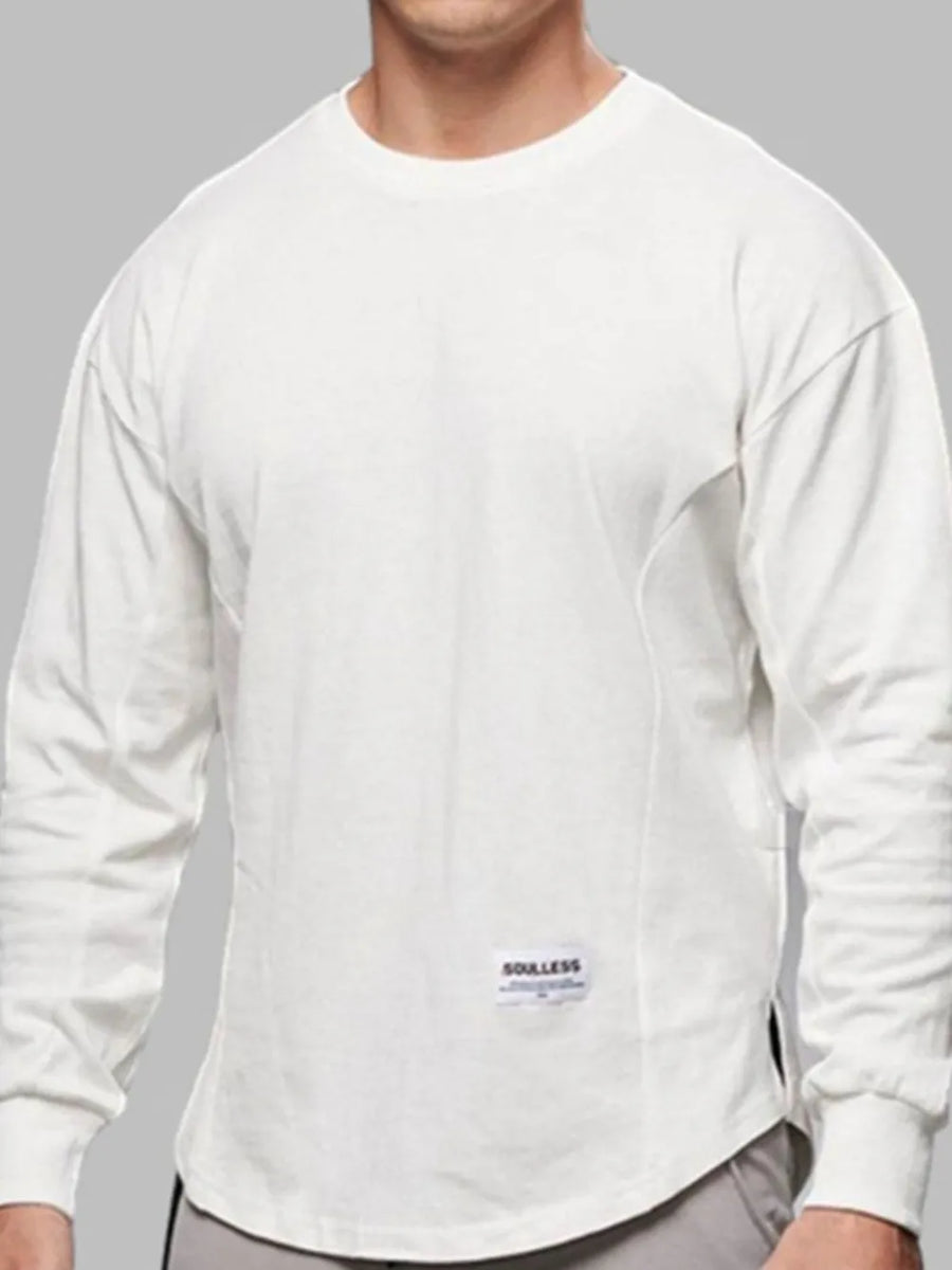 White oversized long sleeve tee with curved hem and crew neck.