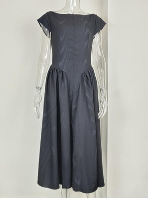 Black cap sleeve A-line midi dress with boat neck and subtle striped pattern.
