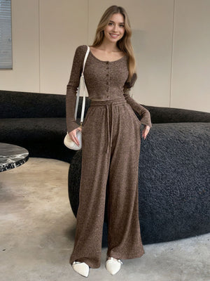 Brown ribbed knit two-piece set with button-down crop top and drawstring wide-leg pants.